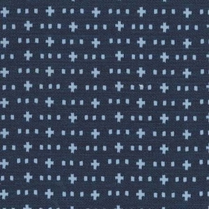 May include: A dark blue fabric with a repeating pattern of white dots and crosses.
