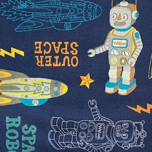 May include: A navy blue fabric with a repeating pattern of robots, rockets, and stars. The text "OUTER SPACE" and "SPACE ROBO" are printed in orange and white.