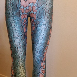 May include: Blue and pink snake print leggings with a high waist.