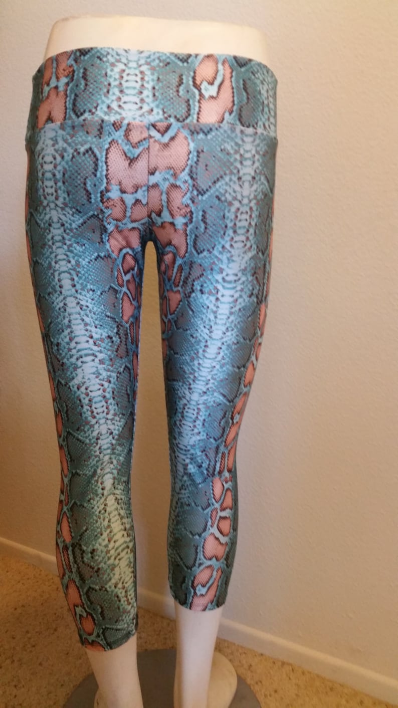May include: Blue and pink snake print leggings with a high waist.