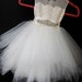 Nichole Davis reviewed Stunning ivory 'Belle' flower girl dress, ivory lace, tea length poufy tulle skirt,  ivory netting with pearl & rhinestone sash, fairy dress