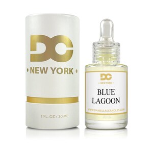 Puede incluir: Una caja cil&iacute;ndrica blanca y un frasco de vidrio de fragancia Blue Lagoon. La caja tiene letras doradas y las palabras "DC NEW YORK". El frasco tiene un cuentagotas y una etiqueta que dice "Blue Lagoon". El frasco contiene 30 ml de l&iacute;quido.