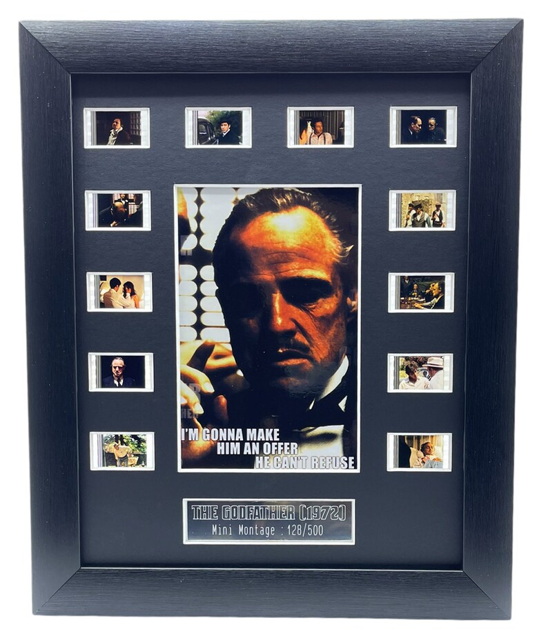May include: A black framed movie montage of The Godfather (1972) with a close-up image of Marlon Brando as Don Vito Corleone. The montage includes 10 film strips and the text "I'm gonna make him an offer he can't refuse." The montage is numbered 128/500.