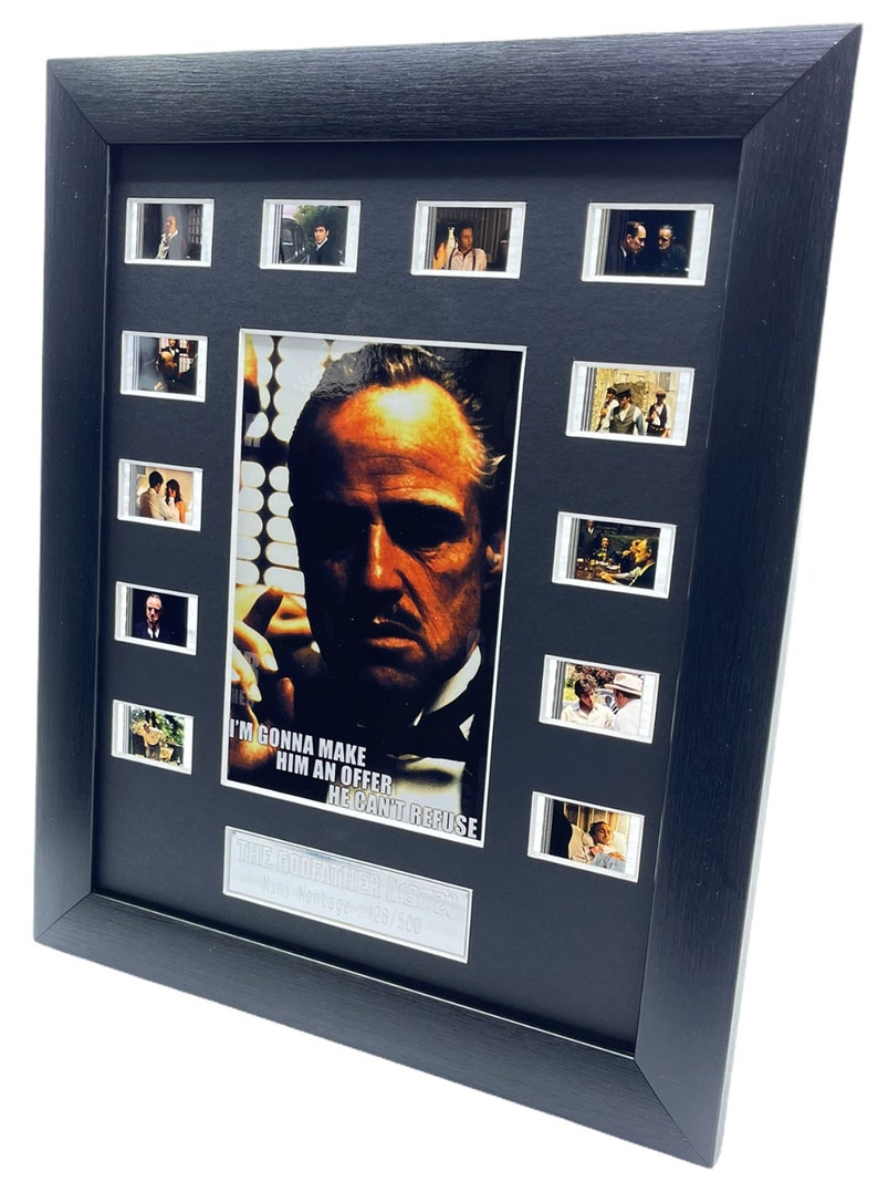 May include: A framed movie poster featuring a close-up of Marlon Brando as Don Vito Corleone from the film "The Godfather". The poster includes a quote from the film: "I'm gonna make him an offer he can't refuse."