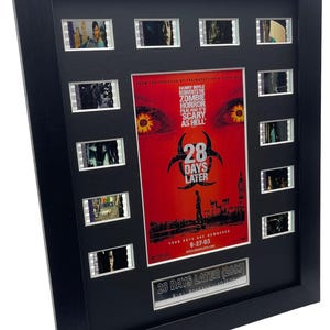 May include: Framed movie film cells and a poster for the film "28 Days Later (2003)". The poster is red with the film title and a silhouette of a person. The frame is black and includes the text "SCARY AS HELL".