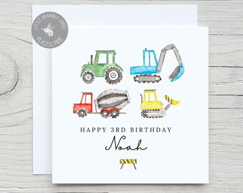 May include: A square white greeting card featuring watercolor illustrations of a green tractor, a blue excavator, a red cement mixer, and a yellow bulldozer. The text reads HAPPY 3RD BIRTHDAY and the name Noah, with a small yellow and black barrier icon.