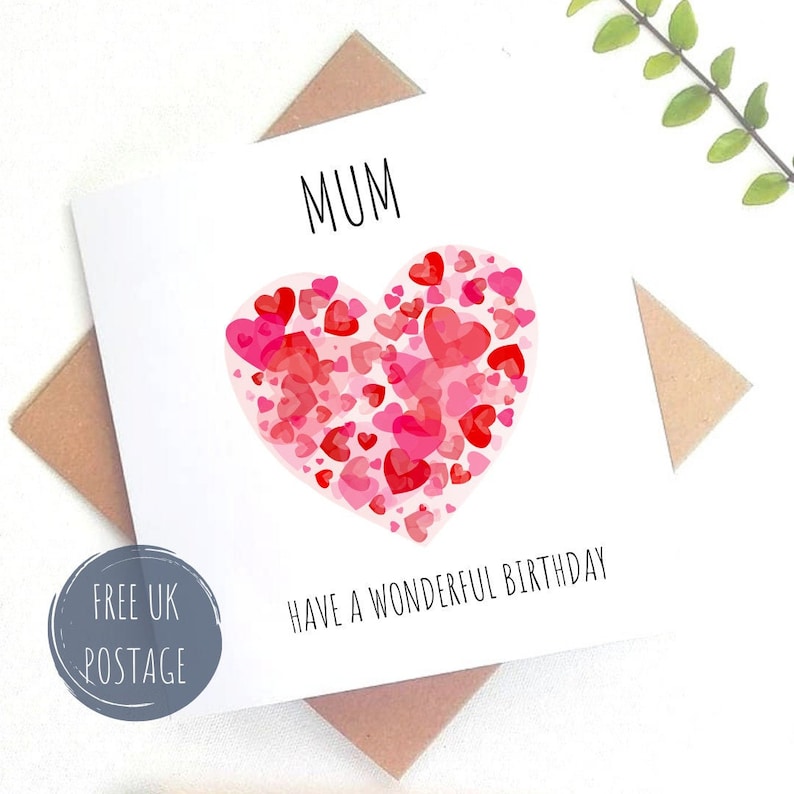 May include: A white card with a red heart made of smaller red hearts. The card says "MUM" and "HAVE A WONDERFUL BIRTHDAY".