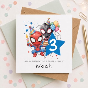 May include: A square birthday greeting card featuring two cartoon spider-themed characters wearing colourful party hats. One holds a lit candle and a slice of cake. A large blue star displays the number 3. Text reads: HAPPY BIRTHDAY TO A SUPER NEPHEW Noah.