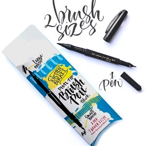 May include: A black dual-tip brush pen with a large and small brush tip. The packaging shows the text "Kirsten Burke's Dual Tip Brush Pen Black" and "1 Pen 1 Brush Sizes Water Resistant Black Ink".
