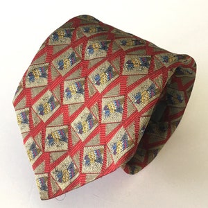 May include: A patterned tie featuring a repeating design of diamond shapes with a red grid overlay. The diamonds have a beige background with blue, yellow, and red accents. The tie is made of a shiny fabric.