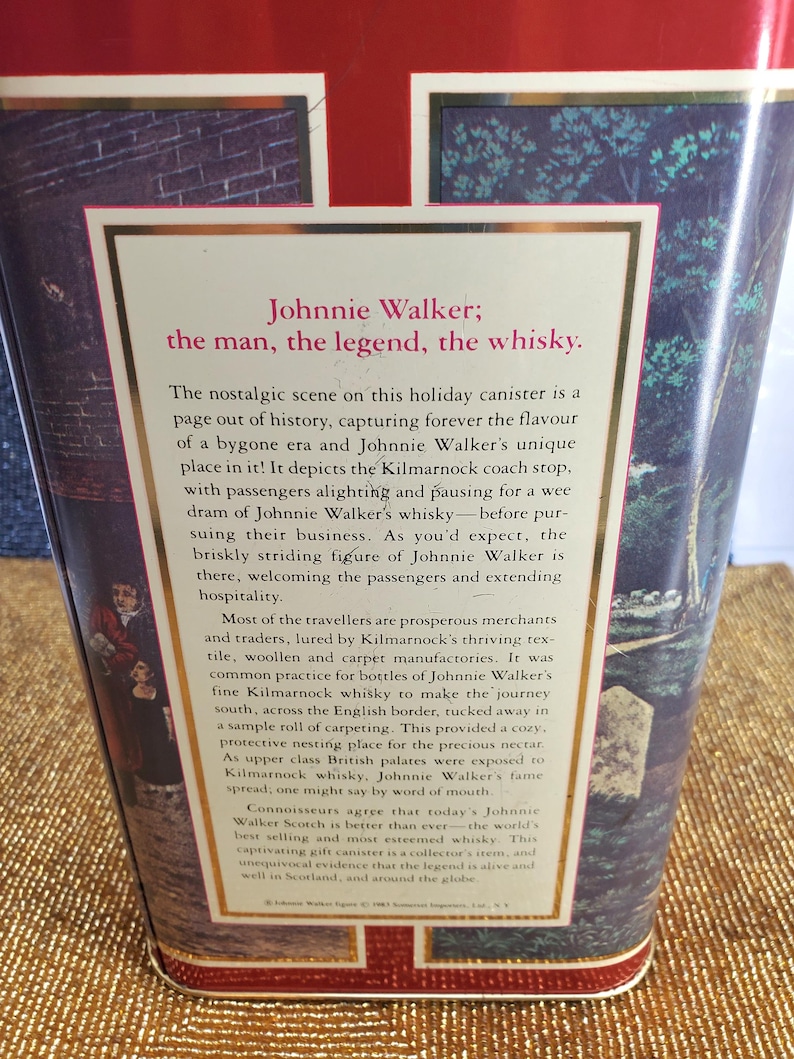 May include: A vintage Johnnie Walker whisky canister with text that reads "Johnnie Walker; the man, the legend, the whisky." The canister features a nostalgic scene with figures and text.