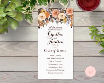 May include: A wedding ceremony order of service card with a floral design in shades of orange, peach, and gold. The card features the names Cynthia and Andrew and the date 27.11.21. The text includes the order of service for the wedding ceremony.