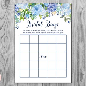 May include: A Bridal Bingo game card with a floral design in shades of blue and green. The card has a grid of squares with the word "Free" in the center. The text "Bridal Bingo" is at the top.
