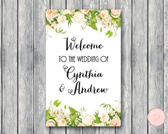 May include: White wedding welcome sign with floral border. The text reads "Welcome to the wedding of Cynthia & Andrew".