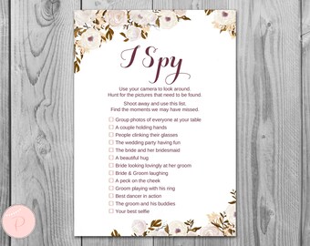 May include: A printable I Spy game card with a floral design. The card has a list of items to find at a wedding reception, such as a couple holding hands, people clinking glasses, and the bride and groom laughing.