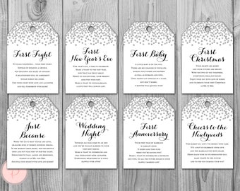 May include: Ten silver glitter gift tags with different occasions printed on them. The tags are white with silver glitter confetti. The text on the tags includes: First Fight, First New Year's Eve, First Baby, First Christmas, Just Because, Wedding Night, First Anniversary, Cheers to the Newlyweds.
