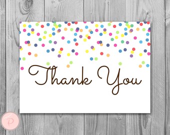 May include: A white card with a colorful confetti design at the top and the text "Thank You" in brown cursive writing.