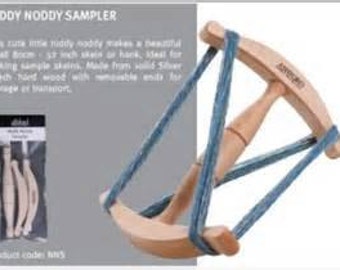 May include: A wooden niddy noddy sampler with a blue yarn wrapped around it. The niddy noddy is made from solid beech wood with removable ends for storage or transport. The product code is 1475.