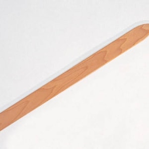 May include: A light brown wooden spatula with a rounded tip and a flat, rectangular handle. The spatula is made of a light-colored wood and has a smooth finish. The spatula is designed for cooking and food preparation.