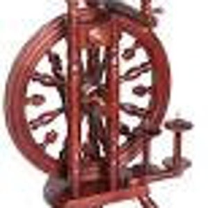 May include: A wooden spinning wheel with a dark red finish. The wheel has a large, round, spoked wheel with a smaller wheel on the side. The spinning wheel is on a stand with three legs.