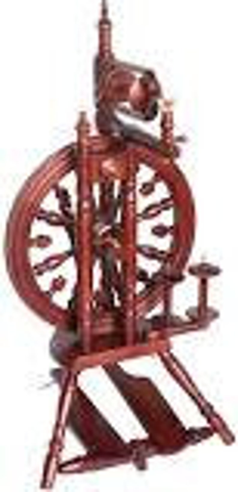 May include: A wooden spinning wheel with a dark red finish. The wheel has a large, round, spoked wheel with a smaller wheel on the side. The spinning wheel is on a stand with three legs.