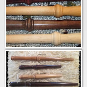 May include: Four wooden dowels, two are 11 inches long and two are 7 inches long. The dowels are made of rosewood and boxwood. The dowels are arranged in two rows, with the longer dowels on top and the shorter dowels on the bottom. The dowels are all natural wood color.