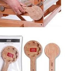 May include: Two wooden loom heddles, one with a hole and the other solid. The heddles are made by Ashford and are packaged in a clear plastic bag.