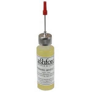 May include: A small, clear bottle of Ashford Spinning Wheel & Loom Oil with a silver cap and a red applicator tip. The bottle has a white label with black text. The oil appears yellow. The product is designed for effortless spinning and high-quality performance.