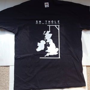 May include: Black t-shirt with a white graphic of the British Isles and the text "SH_THOLE". The shirt is made of a soft material and has a crew neck. The Fruit of the Loom tag is visible.