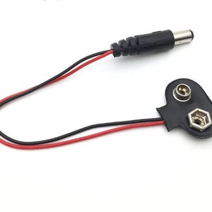 May include: A black and red wire with a black connector on one end and a black connector with two metal terminals on the other end.