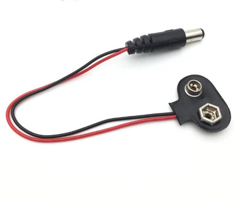 May include: A black and red wire with a black connector on one end and a black connector with two metal terminals on the other end.