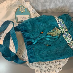 Teal Boho Bucket Bag,  Handmade Up cycled. 14"h x 15"w, 44" strap, round base. Trim, tassel, slide closure. Festival bag, hippie