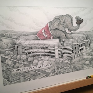 May include: A black and white illustration of an elephant wearing a red and white jersey with the number "1" on it. The elephant is sitting on top of a football stadium with the text "UNIVERSITY OF ALABAMA!" printed below.