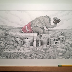 May include: A black and white drawing of an elephant wearing a red and white jersey with the number "1" on it. The elephant is holding a football and is standing on top of a stadium. The stadium is labeled "University of Alabama".