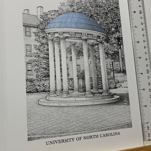 May include: A black and white pen and ink drawing of a building with a blue roof. The building is surrounded by trees and has a sign that reads "UNIVERSITY OF NORTH CAROLINA".