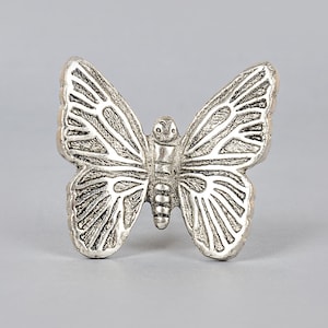 May include: Silver butterfly shaped drawer pull.