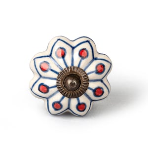 May include: White ceramic cabinet knob with a blue and red floral design. The knob has a brass center.