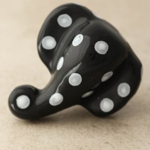 May include: Black ceramic elephant figurine with white polka dots.