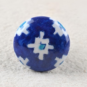 May include: Blue and white ceramic knob with a geometric pattern.