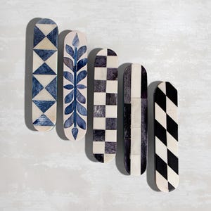 May include: Five decorative bone handles with different geometric patterns. The handles are in shades of black, white, and blue.