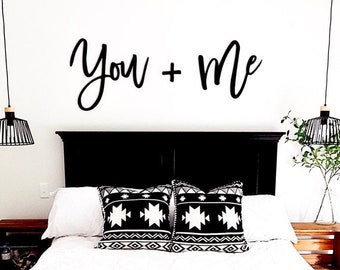 You + Me above bed sign