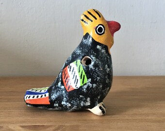 Handmade small clay bird whistle, vintage bright and colourful simple wind instrument, rustic Nicaraguan folk art.