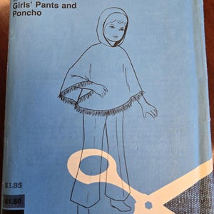 May include: A sewing pattern for girls' pants and a poncho. The pattern is for sizes 8, 10, and 12. The pattern is from the Basic Knits line. The pattern is for knit and stretch fabrics.