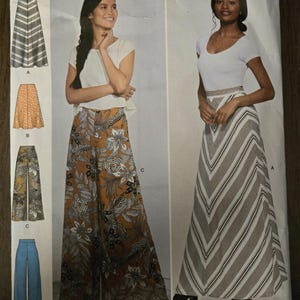 May include: Simplicity sewing pattern S8885 H5 for sizes U.S. 6-14. The envelope displays four garment variations: a chevron-striped maxi skirt, a floral print skirt, wide-leg trousers with a botanical pattern, and solid blue wide-leg trousers.