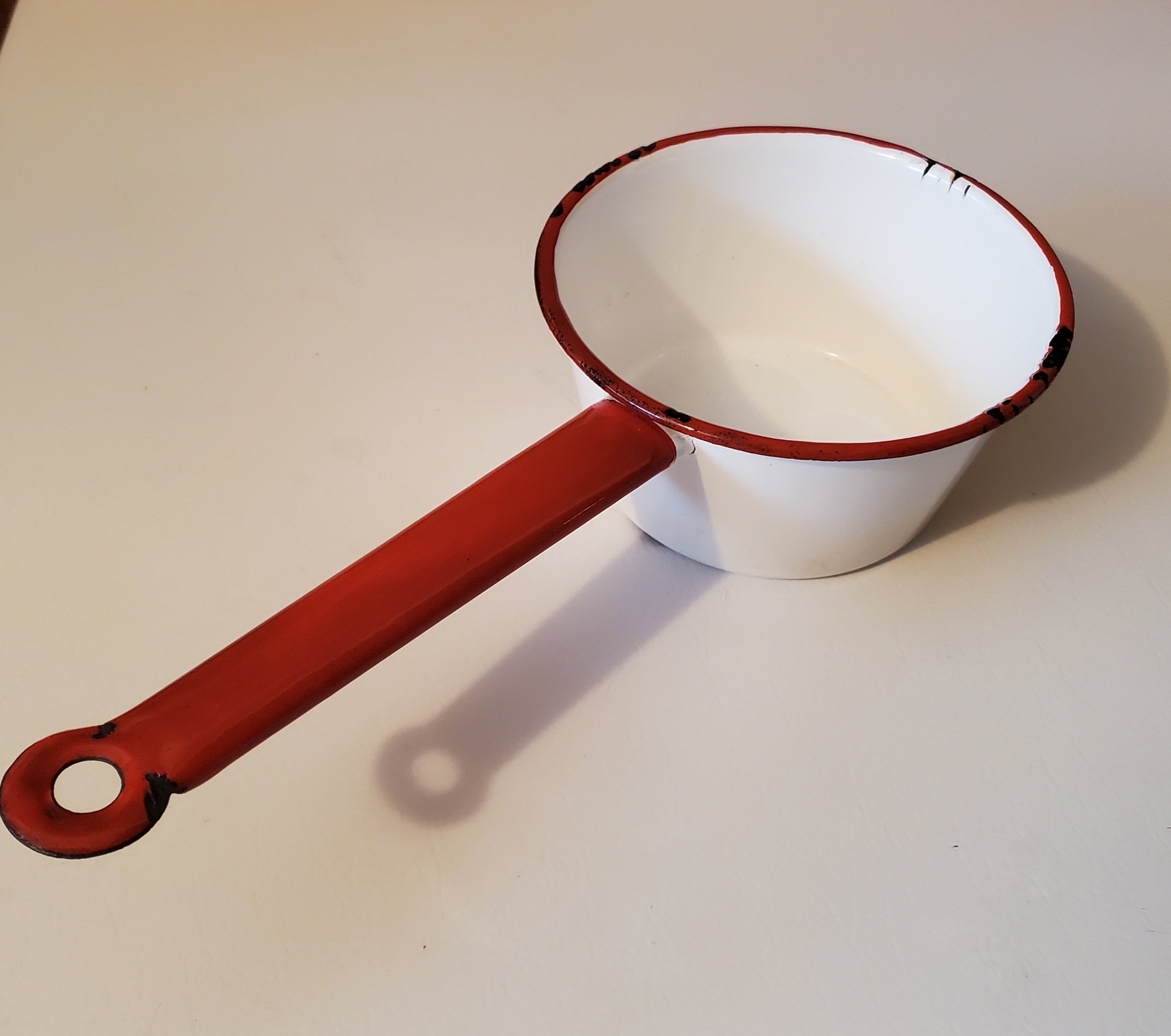 Small vintage enamelware saucepan white with red trim & handle 6" across 3" high preowned with wear