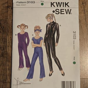May include: A Kwik Sew pattern for children's jumpsuits. The pattern features three jumpsuit styles in sizes 4-5-6-7. The cover shows illustrations of the jumpsuits in purple, blue, and black. The pattern number is 3103.