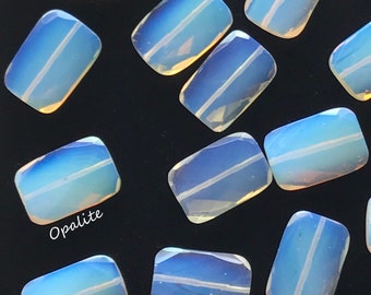 May include: A collection of opalite stones, each with a unique iridescent sheen and a single white line running through the center. The stones are rectangular in shape and have a smooth, polished finish. The word "Opalite" is written in white script at the bottom of the image.