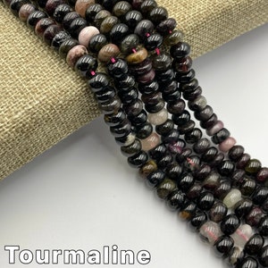 May include: A strand of black tourmaline beads with hints of green, pink, and brown. The beads are round and have a natural, polished finish. Tourmaline Natural Multi-Color.