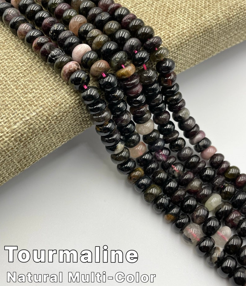 May include: A strand of black tourmaline beads with hints of green, pink, and brown. The beads are round and have a natural, polished finish. Tourmaline Natural Multi-Color.