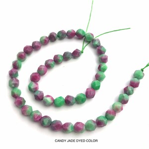 May include: Strands of faceted candy jade beads in shades of green and magenta. The beads are strung on green thread. The text "CANDY JADE DYED COLOR" is at the bottom of the image.